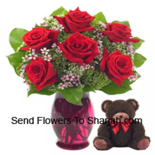 <b>Product Description</b><br><br>6 Red Roses With Some Ferns In A Glass Vase Along With A Cute 14 Inches Tall Teddy Bear<br><br><b>Delivery Information</b><br><br>* The design and packaging of the product can always vary and is subject to the availability of flowers and other products available at the time of delivery.<br><br>* The "Time selected is treated as a preference/request and is not a fixed time for delivery". We only guarantee delivery on a "Specified Date" and not within a specified "Time Frame".