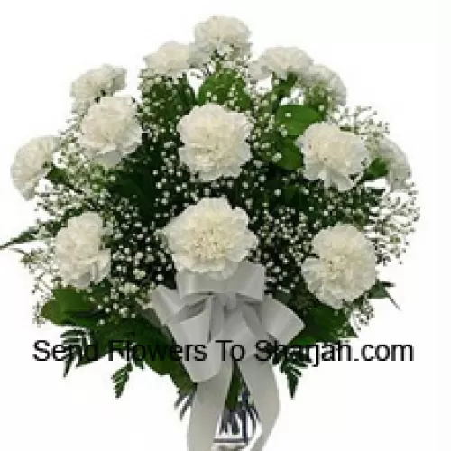 <b>Product Description</b><br><br>18 White Carnations With Seasonal Fillers In A Glass Vase<br><br><b>Delivery Information</b><br><br>* The design and packaging of the product can always vary and is subject to the availability of flowers and other products available at the time of delivery.<br><br>* The "Time selected is treated as a preference/request and is not a fixed time for delivery". We only guarantee delivery on a "Specified Date" and not within a specified "Time Frame".