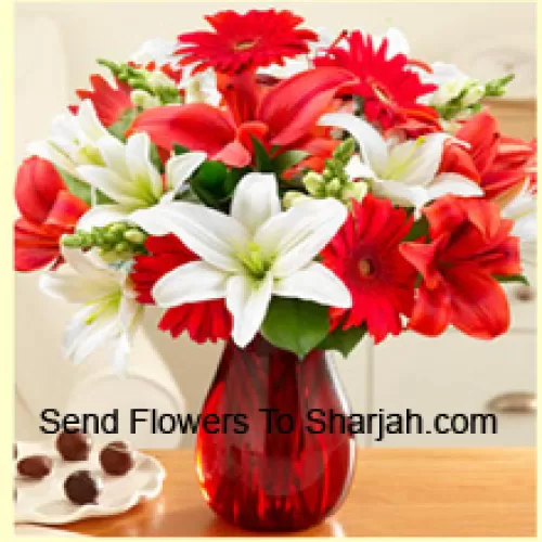 <b>Product Description</b><br><br>Red Gerberas, White Lilies, Red Lilies And Other Assorted Flowers Arranged Beautifully In A Glass Vase<br><br><b>Delivery Information</b><br><br>* The design and packaging of the product can always vary and is subject to the availability of flowers and other products available at the time of delivery.<br><br>* The "Time selected is treated as a preference/request and is not a fixed time for delivery". We only guarantee delivery on a "Specified Date" and not within a specified "Time Frame".