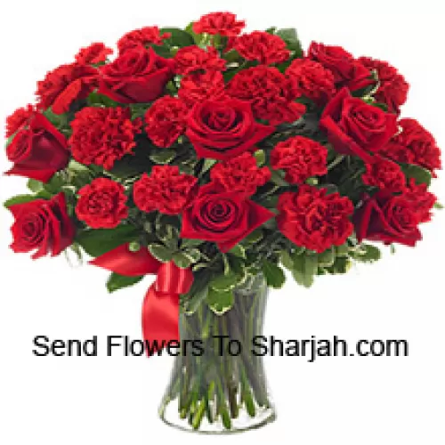 <b>Product Description</b><br><br>12 Red Roses And 12 Red Carnations With Some Ferns In A Glass Vase<br><br><b>Delivery Information</b><br><br>* The design and packaging of the product can always vary and is subject to the availability of flowers and other products available at the time of delivery.<br><br>* The "Time selected is treated as a preference/request and is not a fixed time for delivery". We only guarantee delivery on a "Specified Date" and not within a specified "Time Frame".