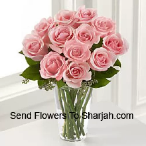 12 Pink Roses With Some Ferns In A Vase