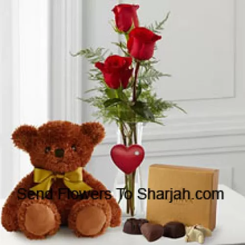 <b>Product Description</b><br><br>Three Red Roses With Some Ferns In A Vase, A Cute Brown 10 Inches Teddy Bear And A Box Of Godiva Chocolates. (We reserve the right to substitute the Godiva chocolates with chocolates of equal value in case of non-availability of the same. Limited Stock)<br><br><b>Delivery Information</b><br><br>* The design and packaging of the product can always vary and is subject to the availability of flowers and other products available at the time of delivery.<br><br>* The "Time selected is treated as a preference/request and is not a fixed time for delivery". We only guarantee delivery on a "Specified Date" and not within a specified "Time Frame".