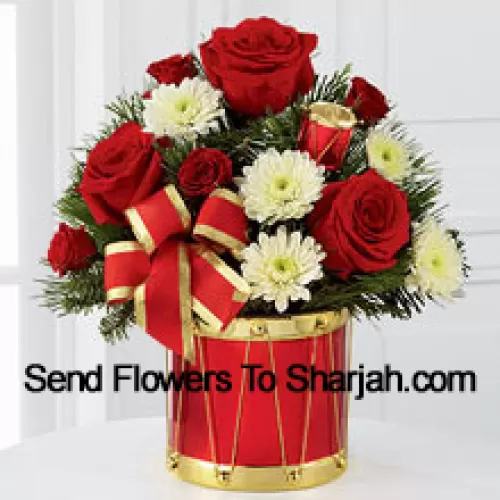 A blossoming display of seasonal merriment and festive greetings. Rich red roses and spray roses sweetly mingle with white chrysanthemums arranged amongst lush holiday greens, all perfectly accented with drum pics and a gold-edged red ribbon. Arriving in a designer red and gold drum inspired vase, this bouquet will express your most heartfelt wishes for a wonderful holiday season. (Please Note That We Reserve The Right To Substitute Any Product With A Suitable Product Of Equal Value In Case Of Non-Availability Of A Certain Product)